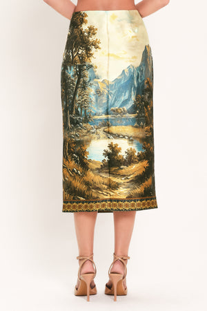 A model wearing a high-waisted midi skirt with a detailed landscape print of mountains, lakes, and trees | Flying Tomato