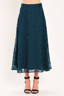 A dark teal blue midi skirt with a subtle tonal leaf pattern | Flying Tomato