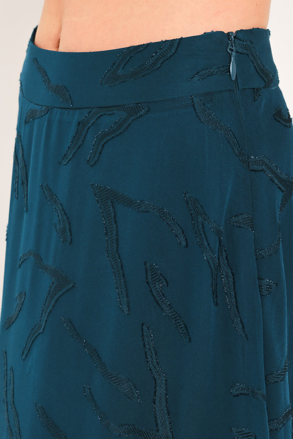 A dark teal blue midi skirt with a subtle tonal leaf pattern | Flying Tomato