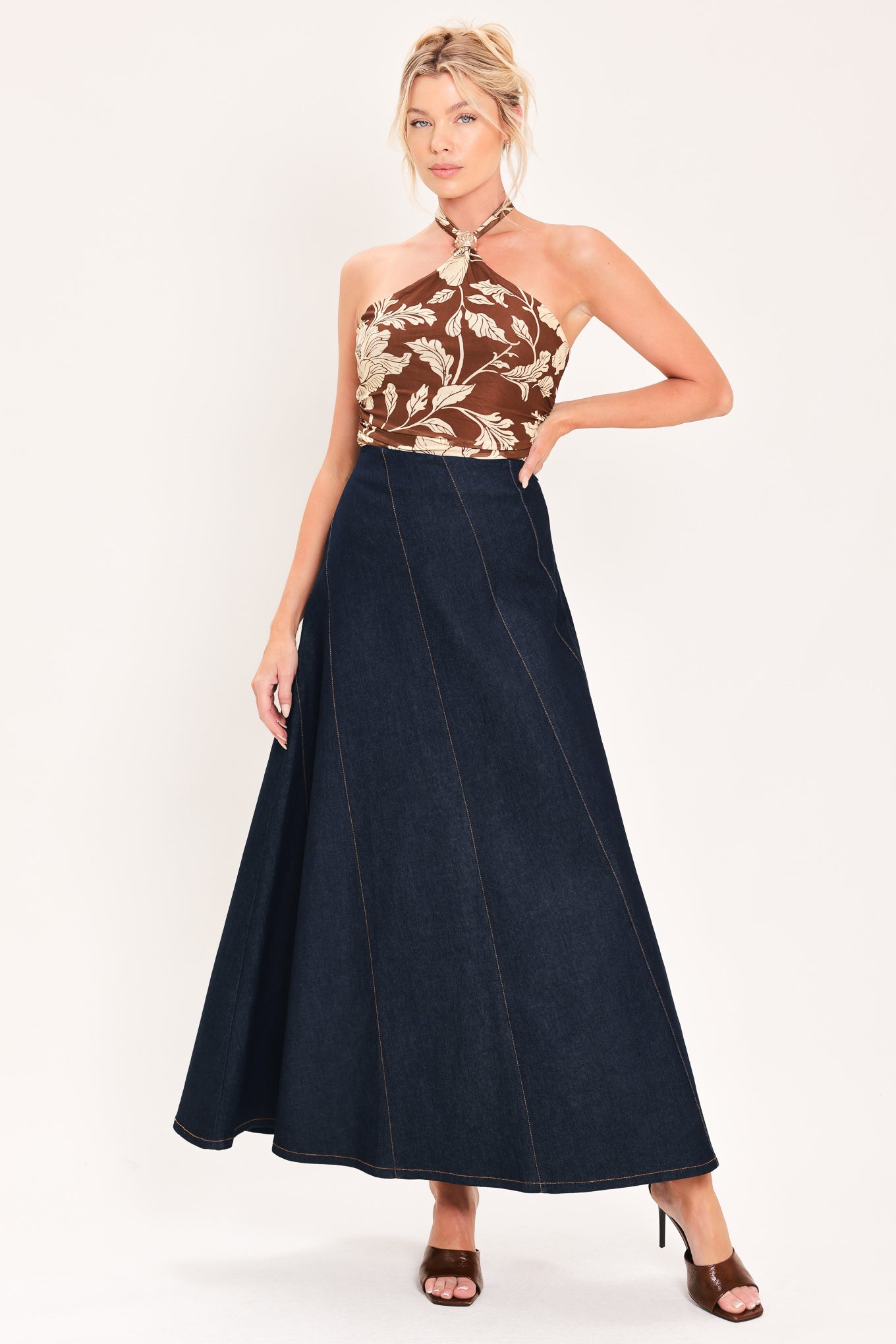A dark navy blue denim maxi skirt with diagonal seam details, shown on a model | Flying Tomato