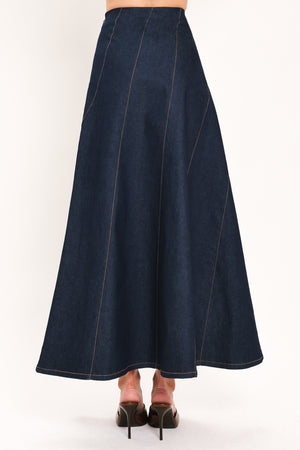 A dark navy blue denim maxi skirt with diagonal seam details, shown on a model | Flying Tomato