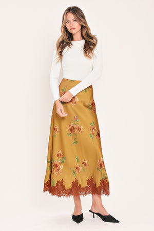A camel yellow midi skirt with a brown and green floral print and a brown lace hem | Flying Tomato