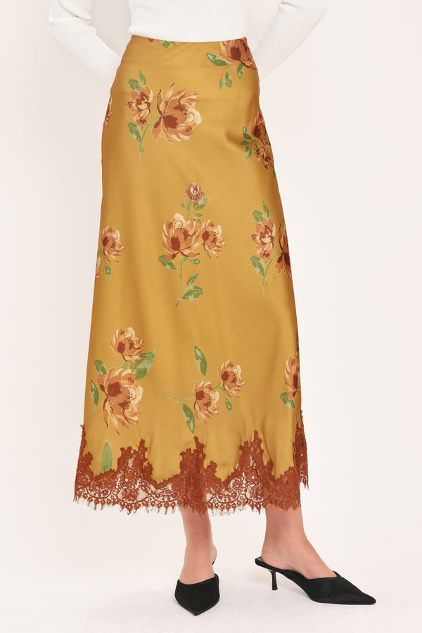 A camel yellow midi skirt with a brown and green floral print and a brown lace hem | Flying Tomato