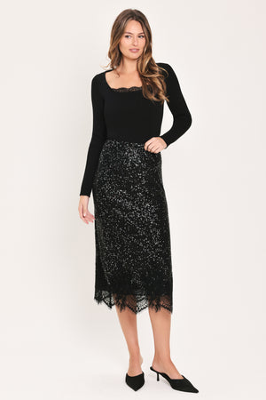 A woman modeling a black sequined midi skirt with a lace hem | Flying Tomato