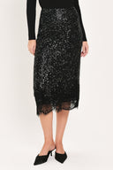 A woman modeling a black sequined midi skirt with a lace hem | Flying Tomato