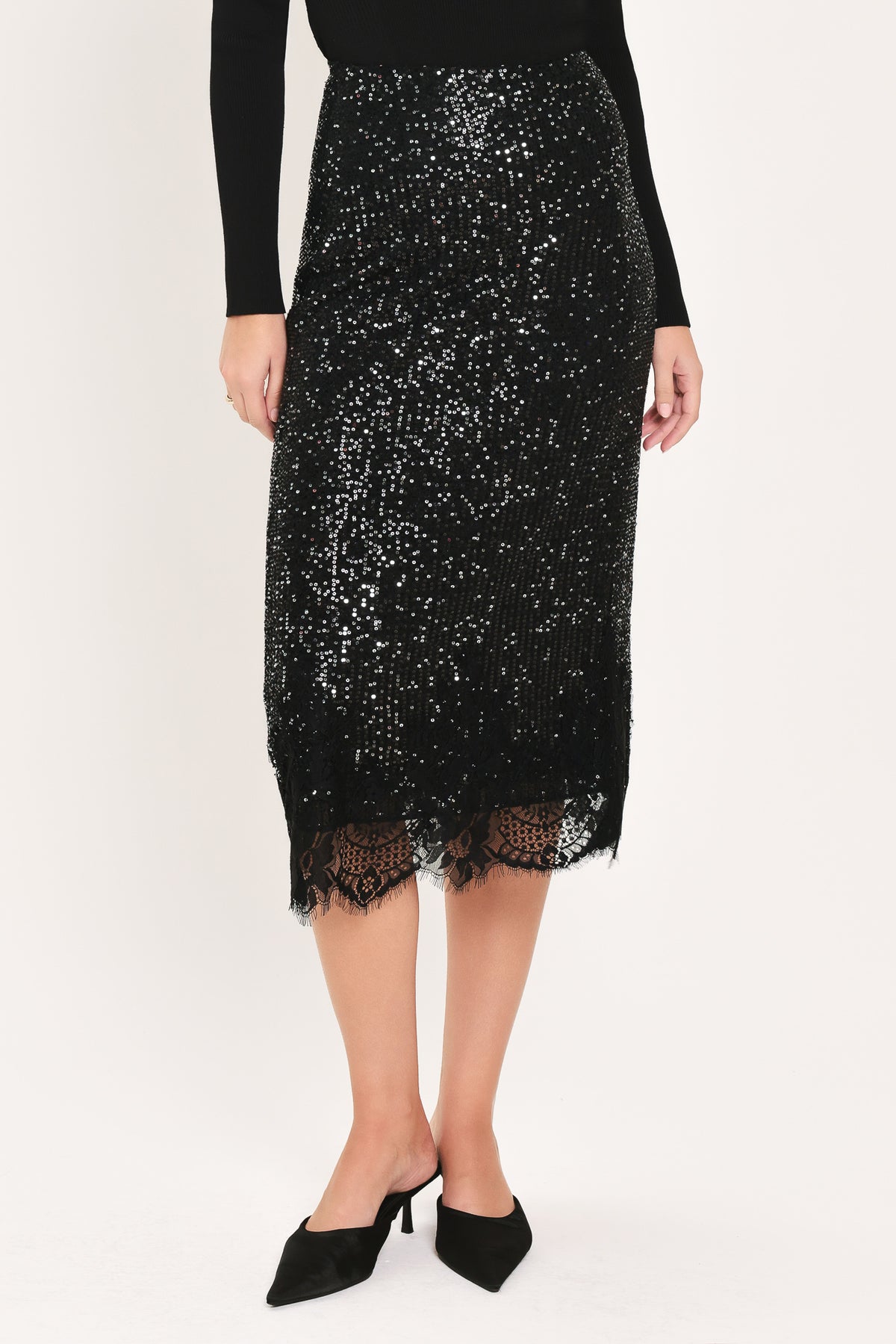 A woman modeling a black sequined midi skirt with a lace hem | Flying Tomato