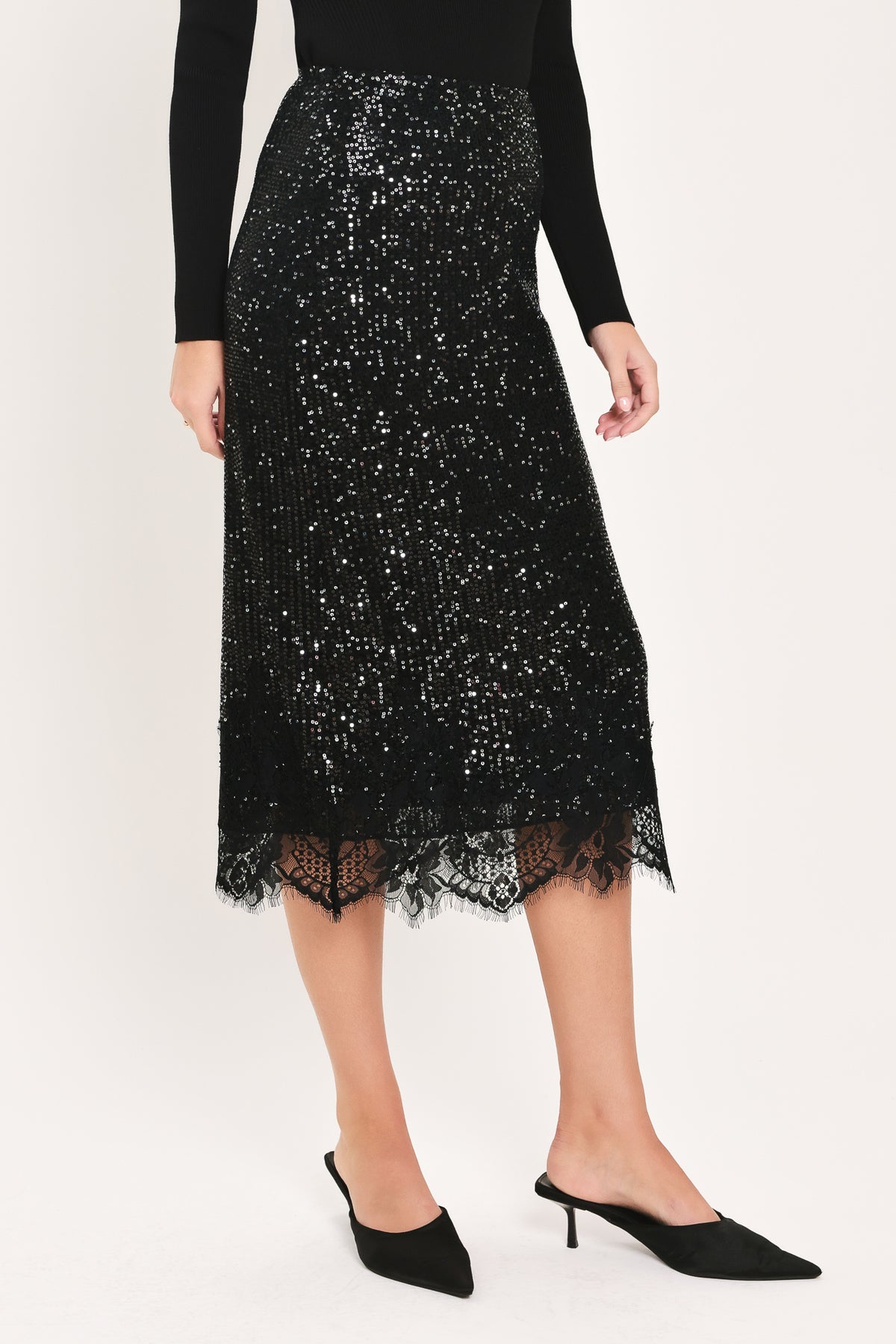 A woman modeling a black sequined midi skirt with a lace hem | Flying Tomato