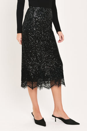 A woman modeling a black sequined midi skirt with a lace hem | Flying Tomato