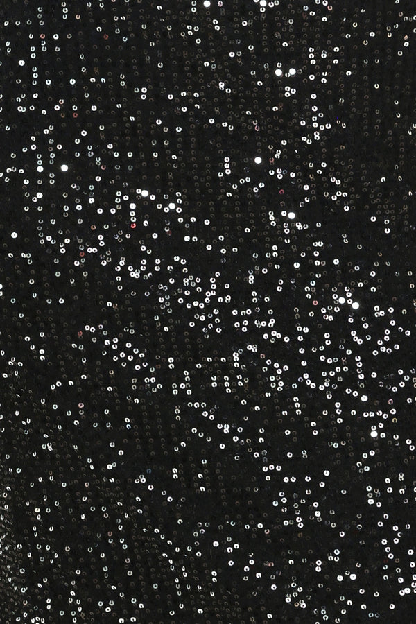A woman modeling a black sequined midi skirt with a lace hem | Flying Tomato
