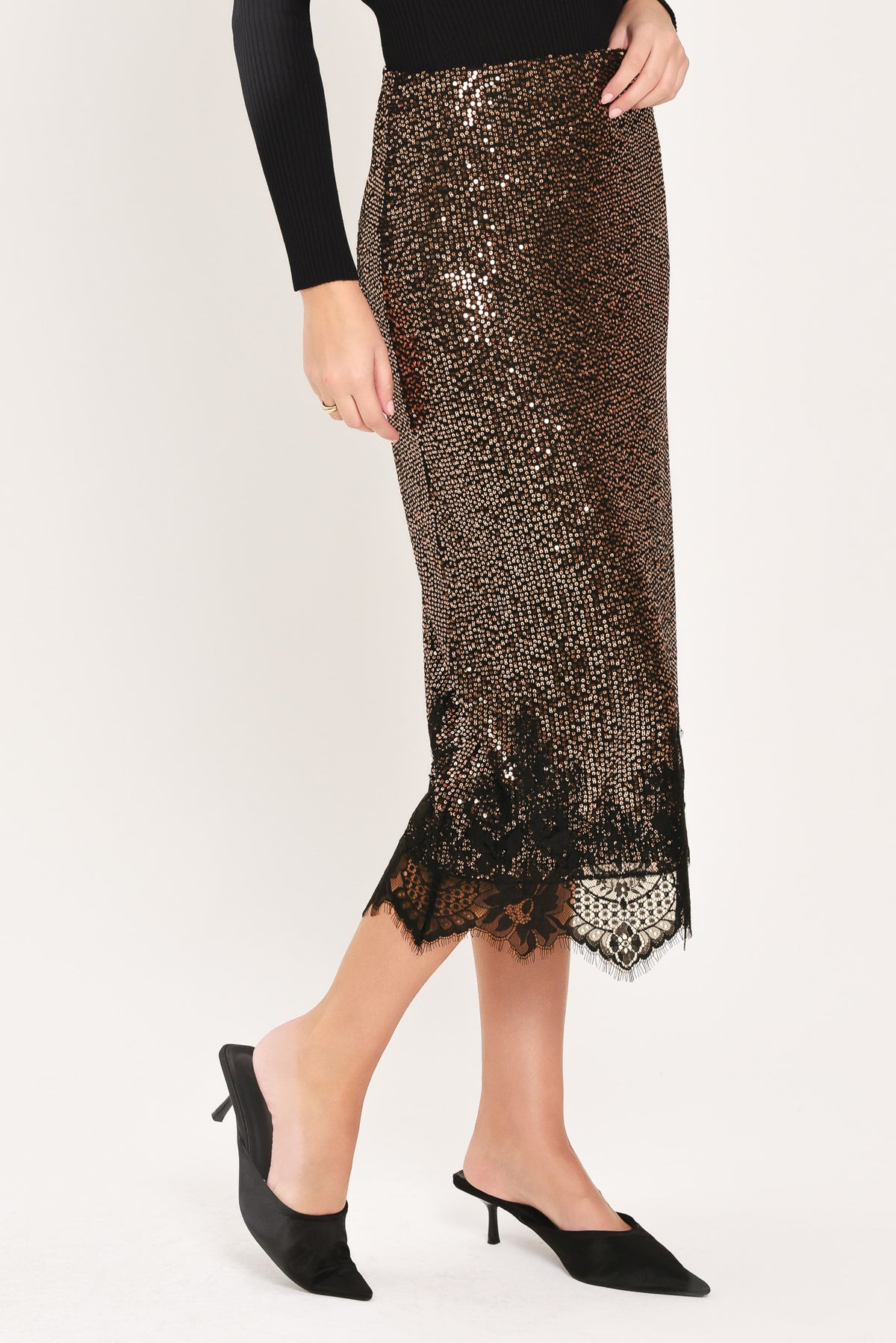 A woman modeling a bronze sequined midi skirt with a black lace hem | Flying Tomato