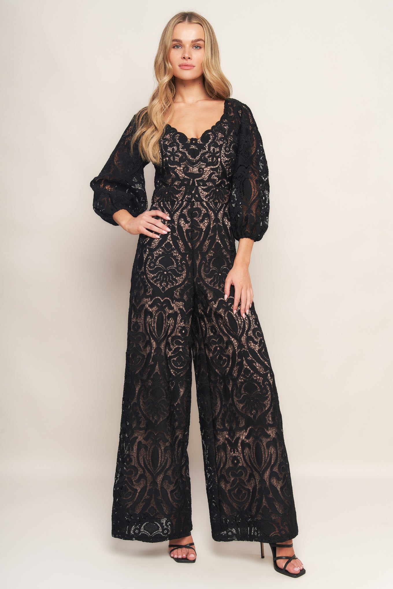 A woven lace jumpsuit featuring U neckline, 3/4 sleeve, wide leg and back zipper closure
