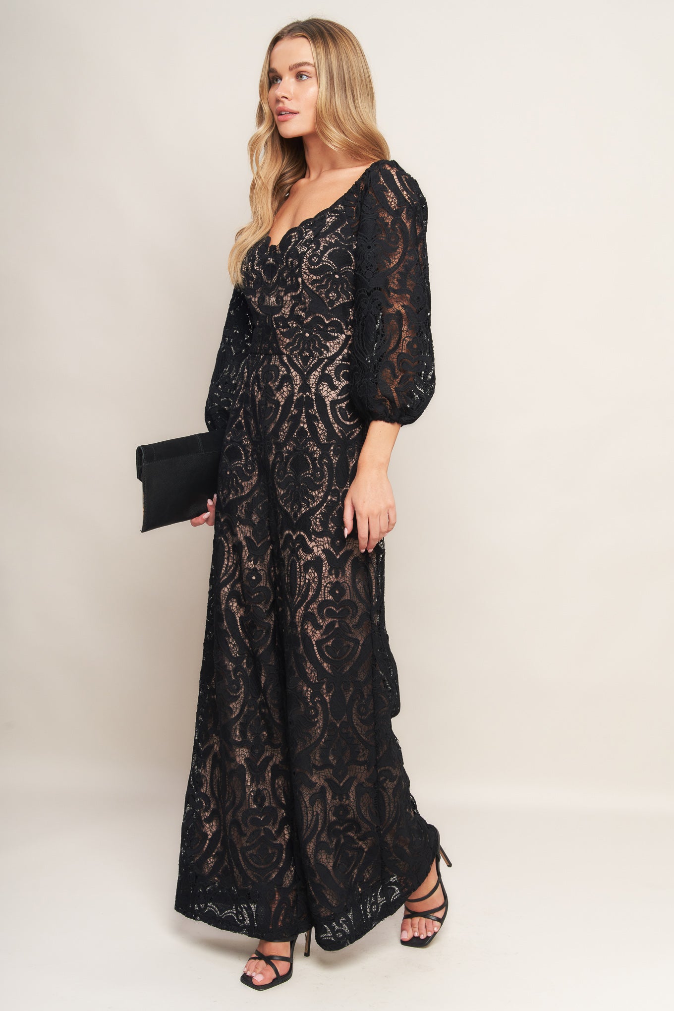 A woven lace jumpsuit featuring U neckline, 3/4 sleeve, wide leg and back zipper closure