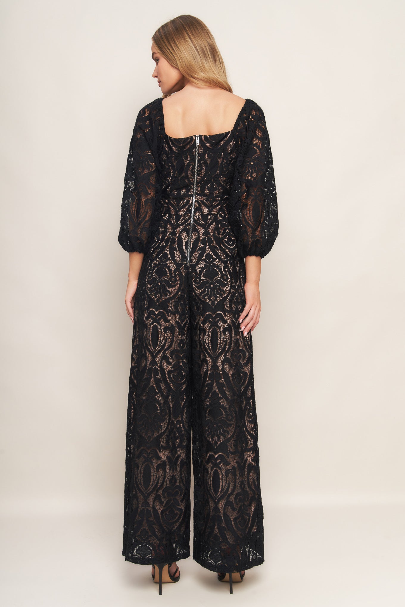 A woven lace jumpsuit featuring U neckline, 3/4 sleeve, wide leg and back zipper closure