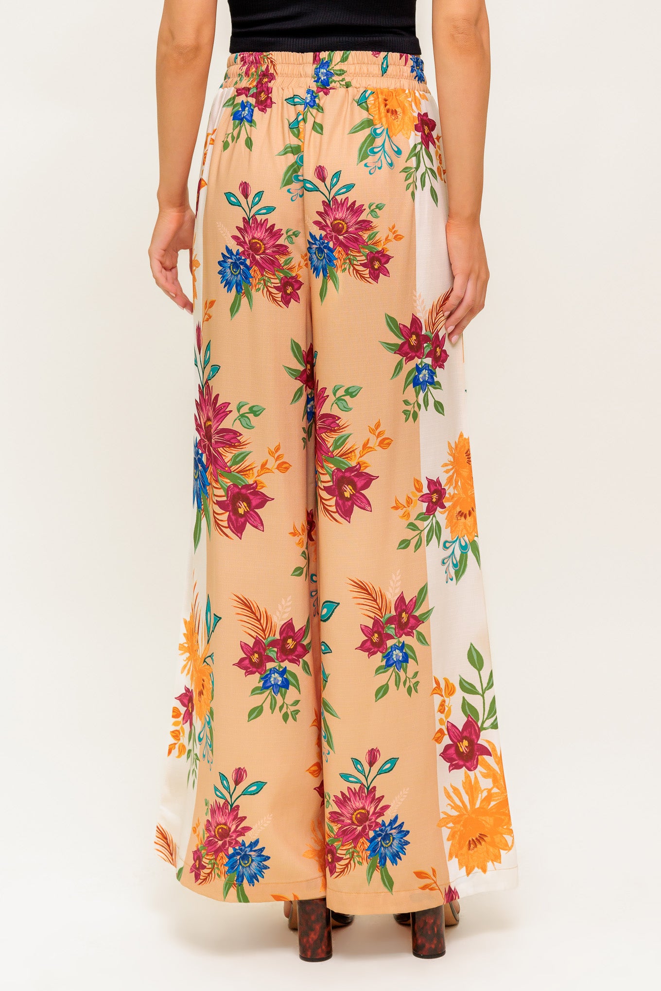 A printed woven pant with elasticized waist and tie