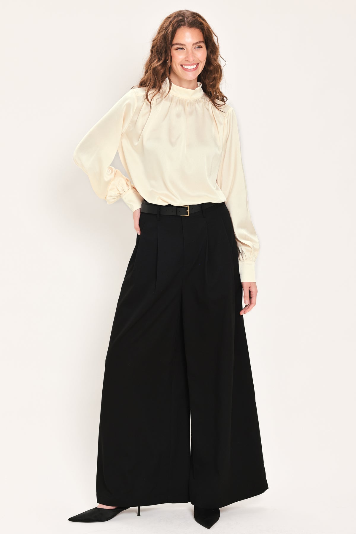 Woman wearing high-waisted, wide-leg trousers with pleats and coordinating belt | Flying Tomato