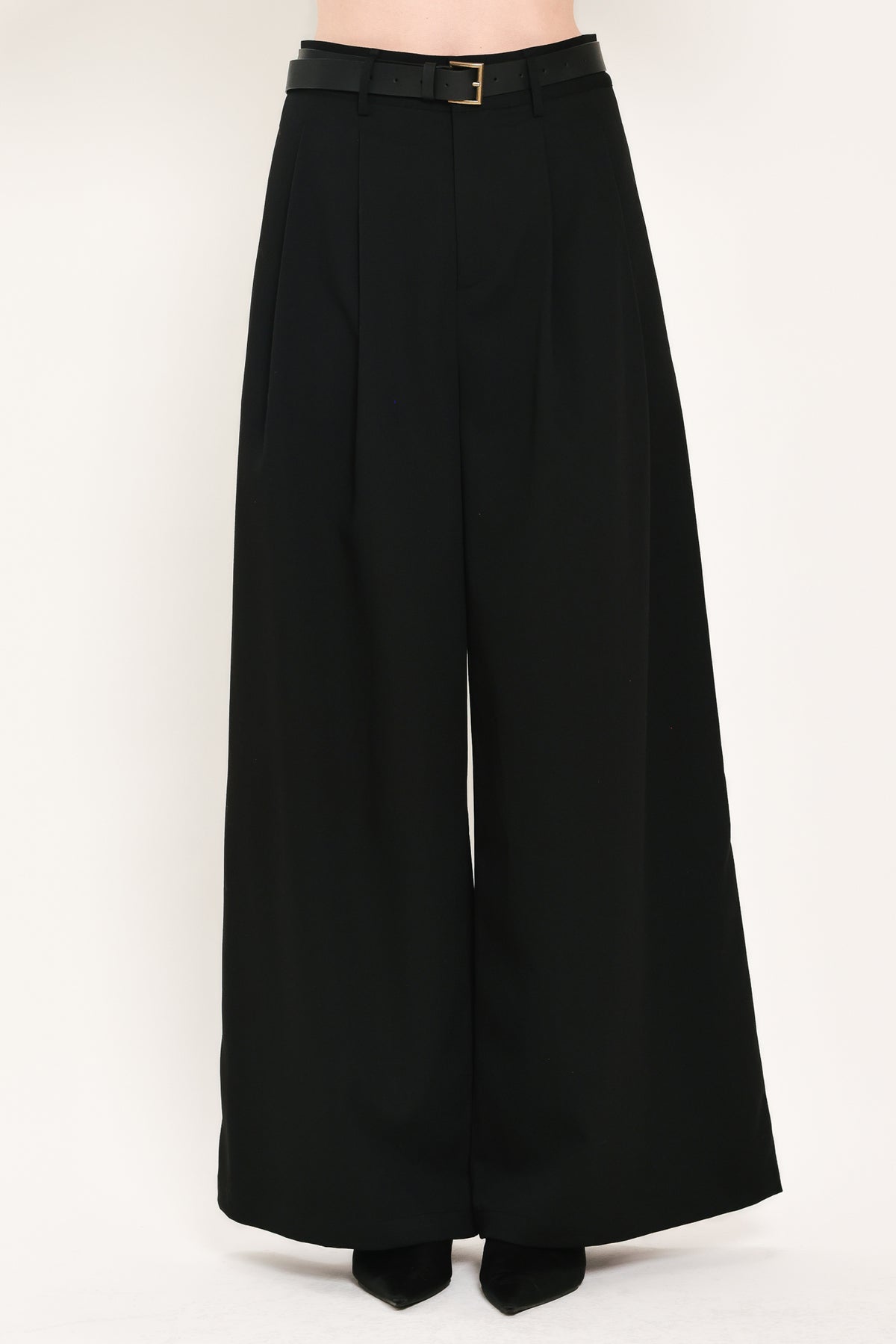 Woman wearing high-waisted, wide-leg trousers with pleats and coordinating belt | Flying Tomato