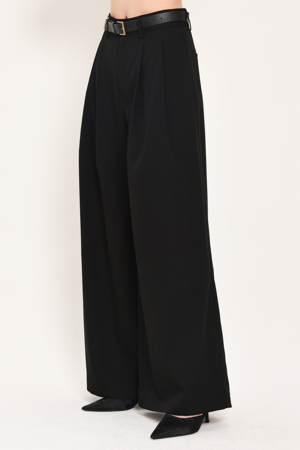 Woman wearing high-waisted, wide-leg trousers with pleats and coordinating belt | Flying Tomato