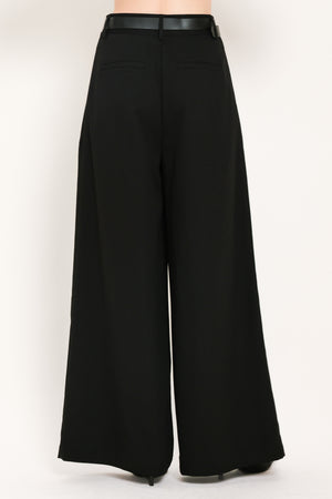 Woman wearing high-waisted, wide-leg trousers with pleats and coordinating belt | Flying Tomato