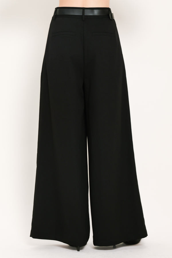 Woman wearing high-waisted, wide-leg trousers with pleats and coordinating belt | Flying Tomato