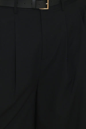 Woman wearing high-waisted, wide-leg trousers with pleats and coordinating belt | Flying Tomato