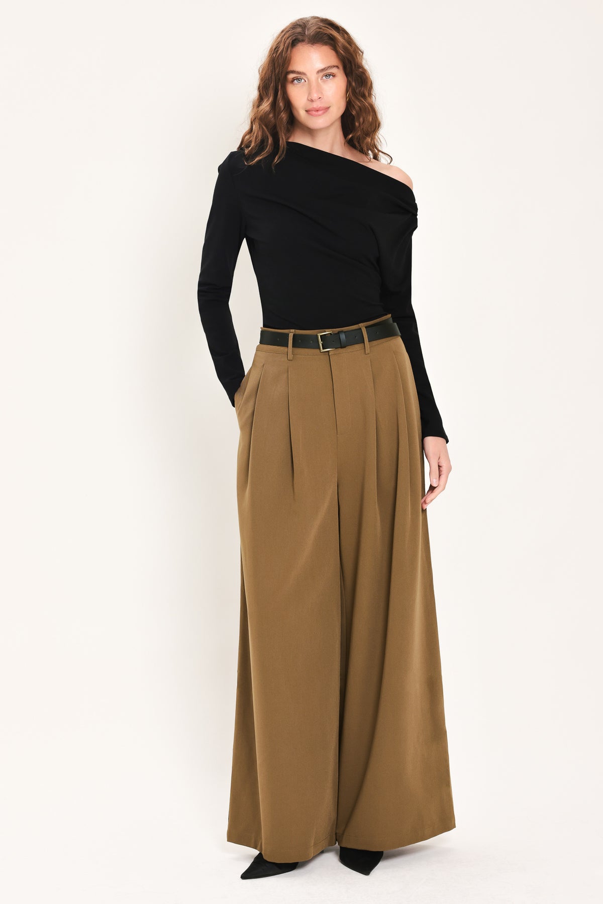 Woman wearing high-waisted, wide-leg trousers with pleats and coordinating belt | Flying Tomato