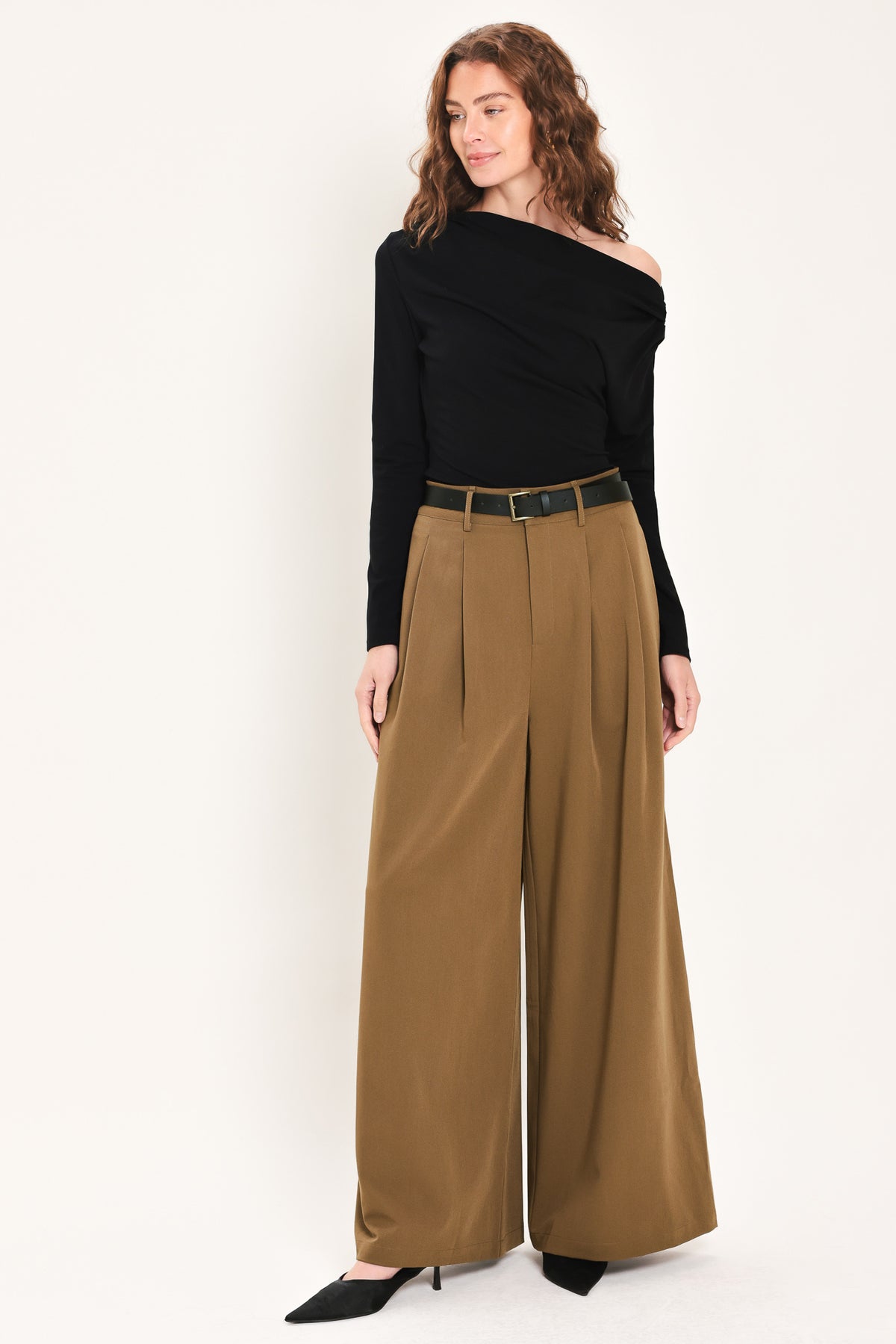 Woman wearing high-waisted, wide-leg trousers with pleats and coordinating belt | Flying Tomato