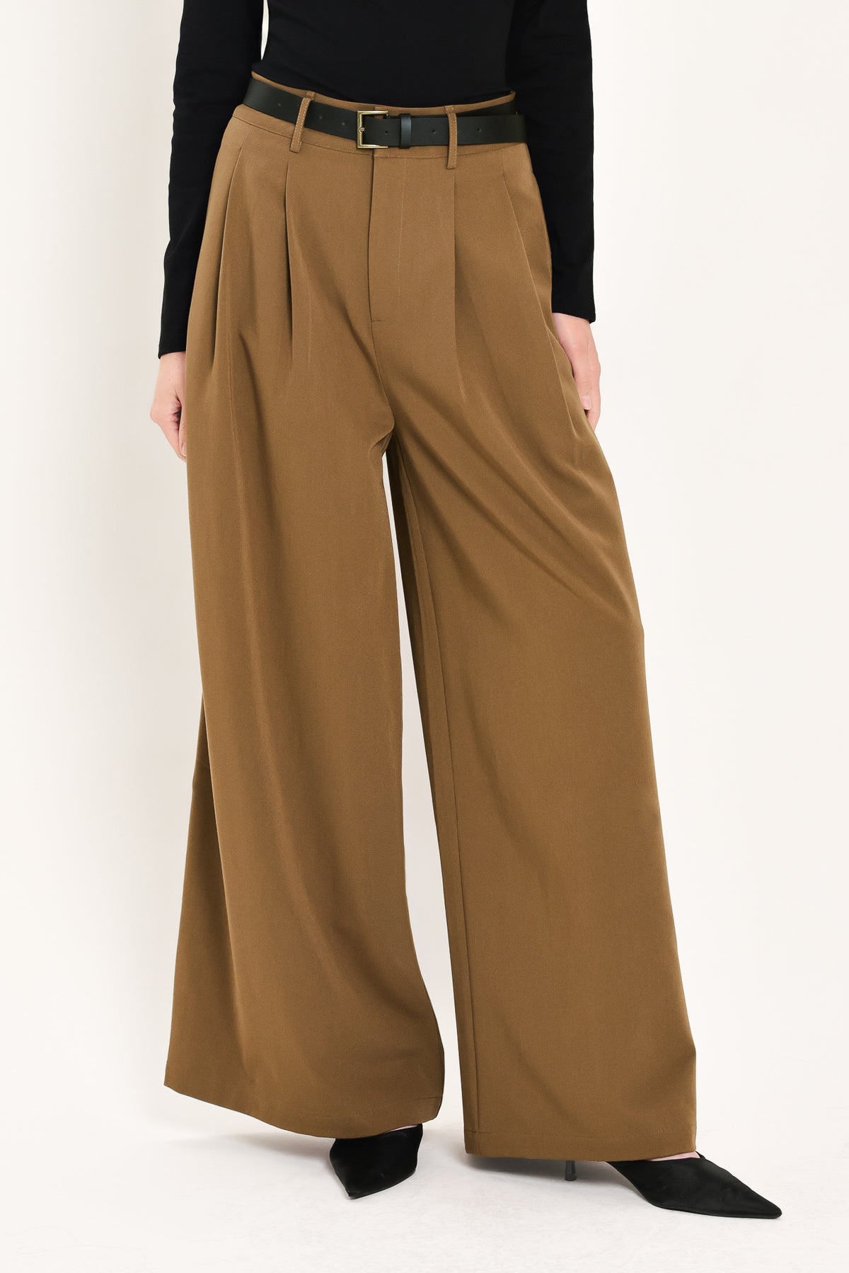 Woman wearing high-waisted, wide-leg trousers with pleats and coordinating belt | Flying Tomato