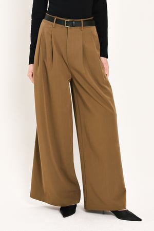 Woman wearing high-waisted, wide-leg trousers with pleats and coordinating belt | Flying Tomato