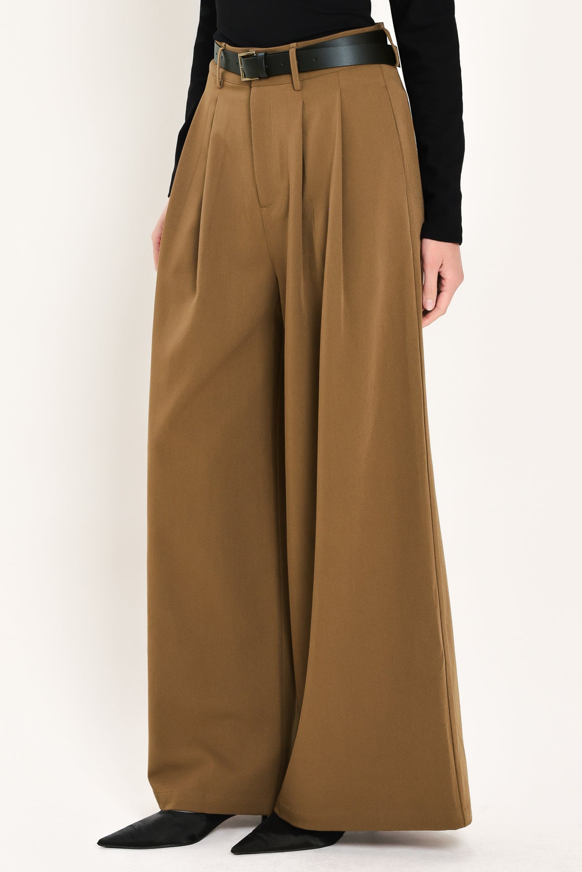 Woman wearing high-waisted, wide-leg trousers with pleats and coordinating belt | Flying Tomato