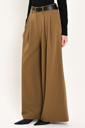 Woman wearing high-waisted, wide-leg trousers with pleats and coordinating belt | Flying Tomato