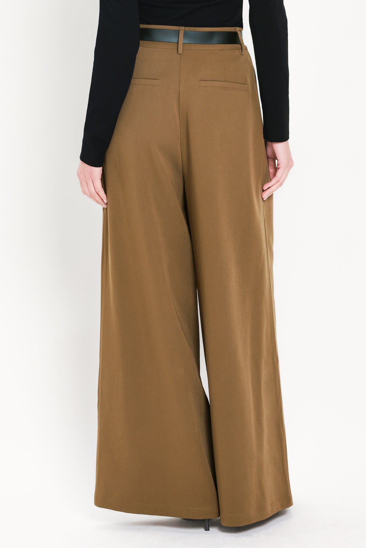 Woman wearing high-waisted, wide-leg trousers with pleats and coordinating belt | Flying Tomato