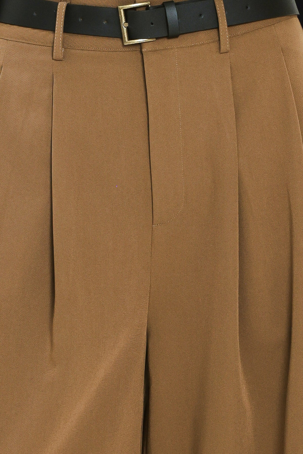 Woman wearing high-waisted, wide-leg trousers with pleats and coordinating belt | Flying Tomato