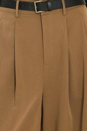 Woman wearing high-waisted, wide-leg trousers with pleats and coordinating belt | Flying Tomato