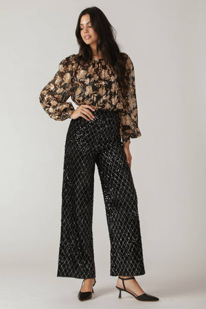 Woman wearing black sequin pants | FREEMARKET