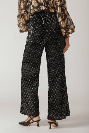 Woman wearing black sequin pants | FREEMARKET