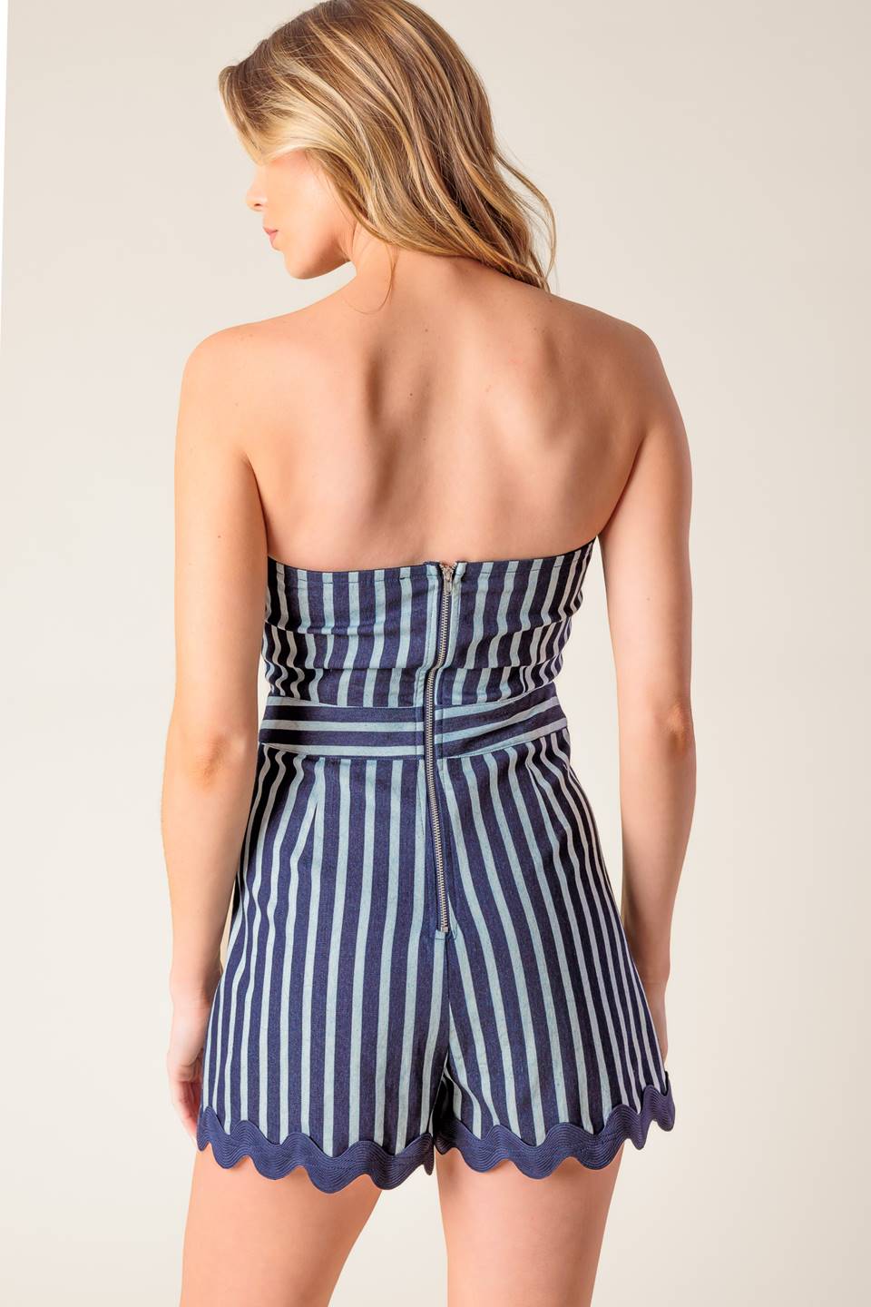 A striped woven skort romper featuring off shoulder neckline, ric rac ribbon hem and back zipper closure.