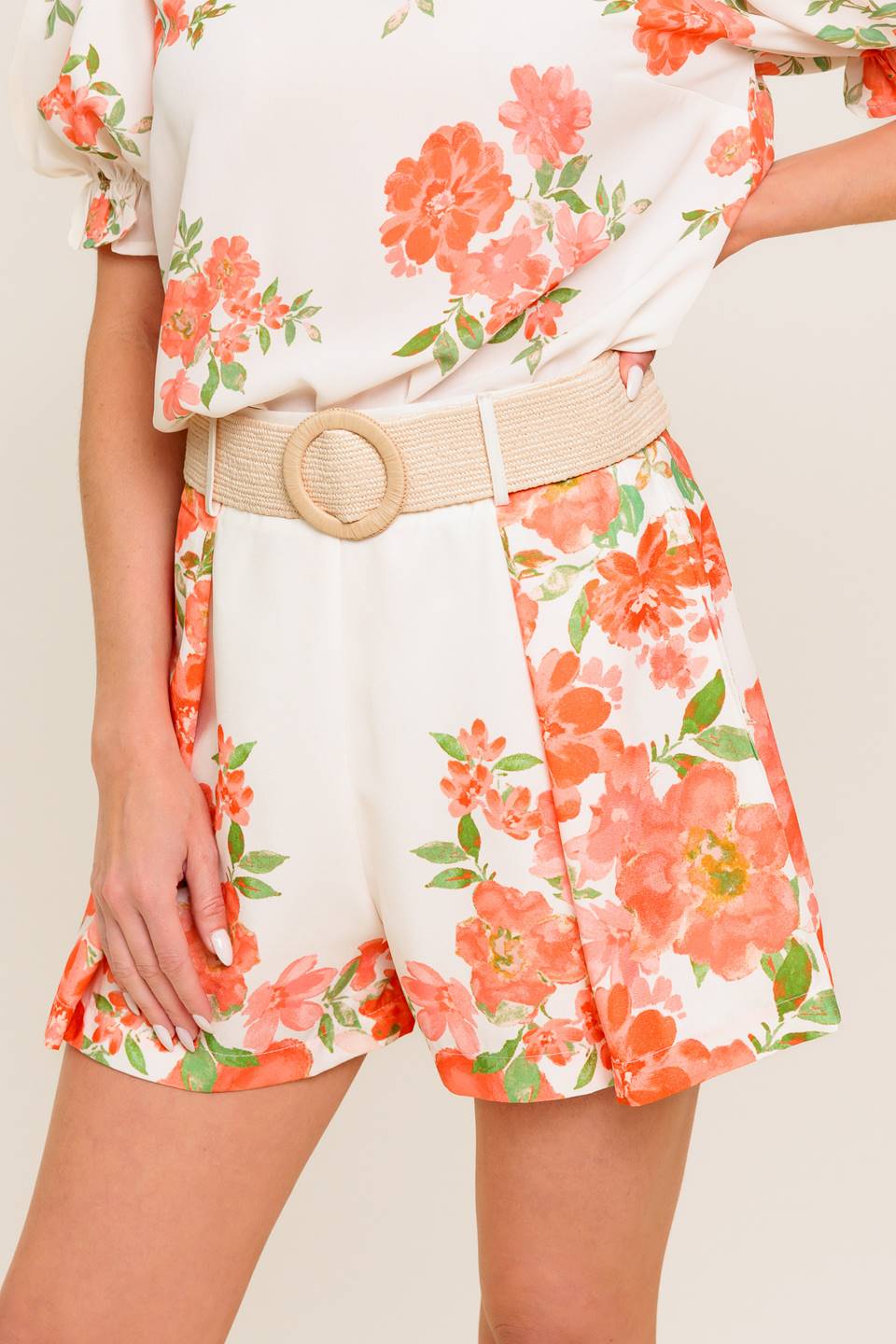 A printed woven short featuring belt and side zipper closure.