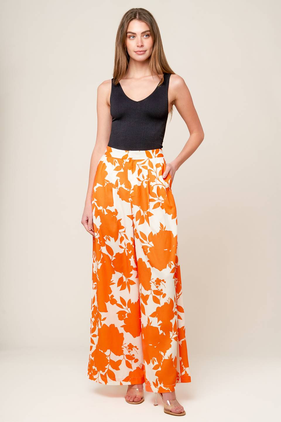 expertly crafted white and orange printed woven pants, featuring a wide-leg design, convenient front closure, and functional side pockets.