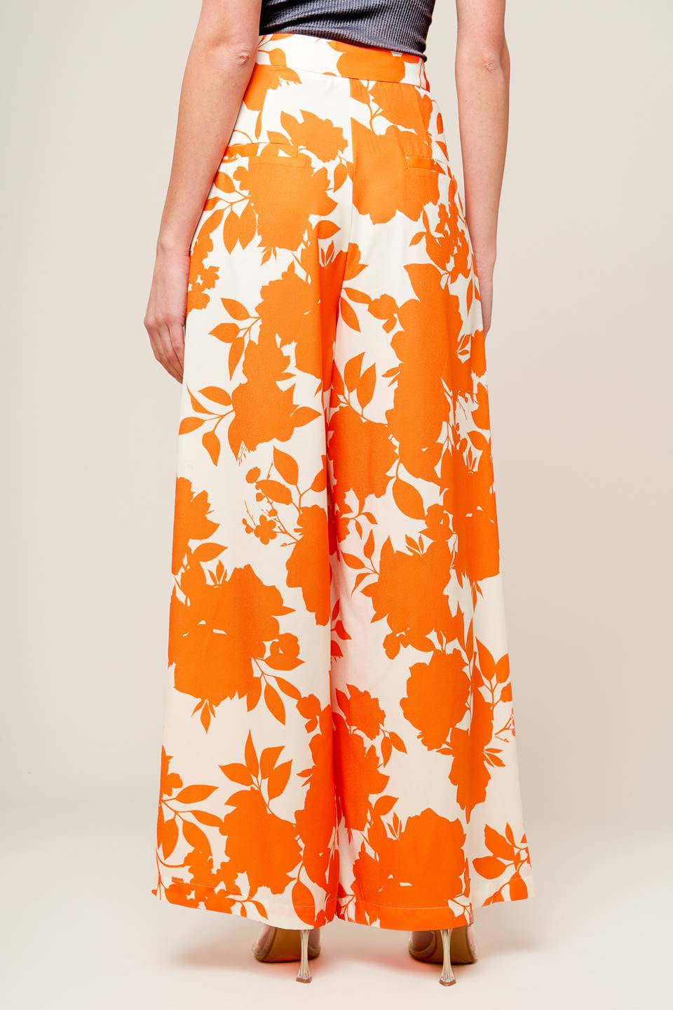 expertly crafted white and orange printed woven pants, featuring a wide-leg design, convenient front closure, and functional side pockets.