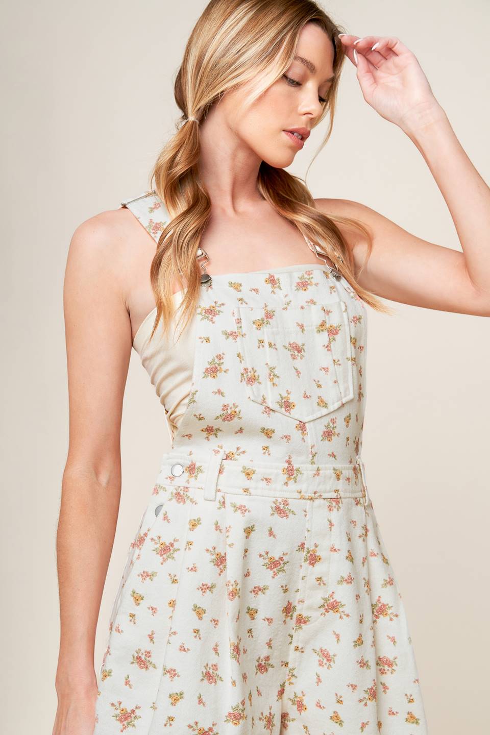 A floral printed woven overall romper.