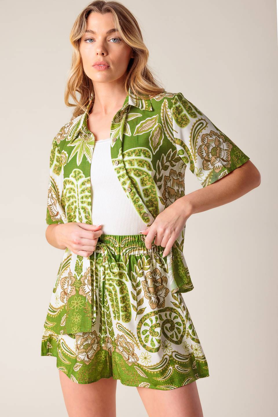 A flowy ivory and green printed short featuring elasticized waistband with front tie.