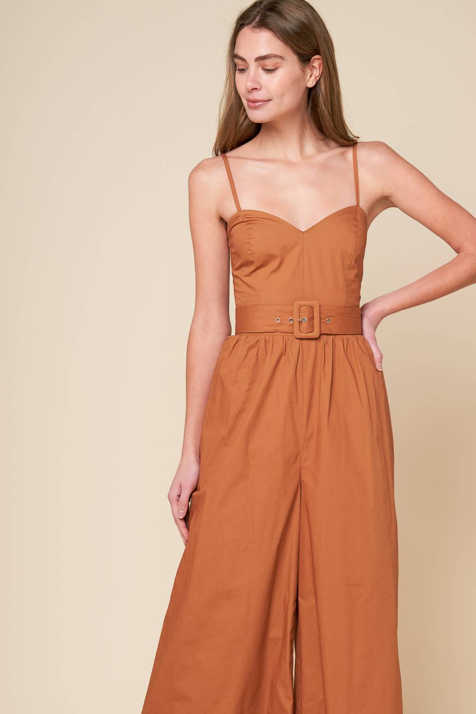 A stylish jumpsuit with a woven design and a cami top, complete with straps and a self belt. Also includes a smocked back bodice and wide leg for added comfort.