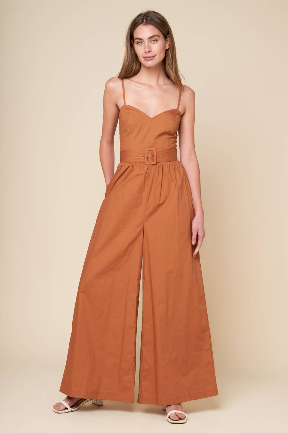 A stylish jumpsuit with a woven design and a cami top, complete with straps and a self belt. Also includes a smocked back bodice and wide leg for added comfort.