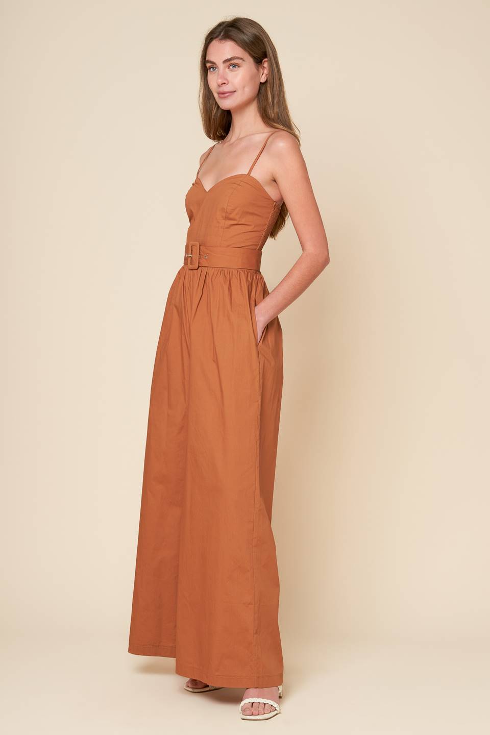 A stylish jumpsuit with a woven design and a cami top, complete with straps and a self belt. Also includes a smocked back bodice and wide leg for added comfort.