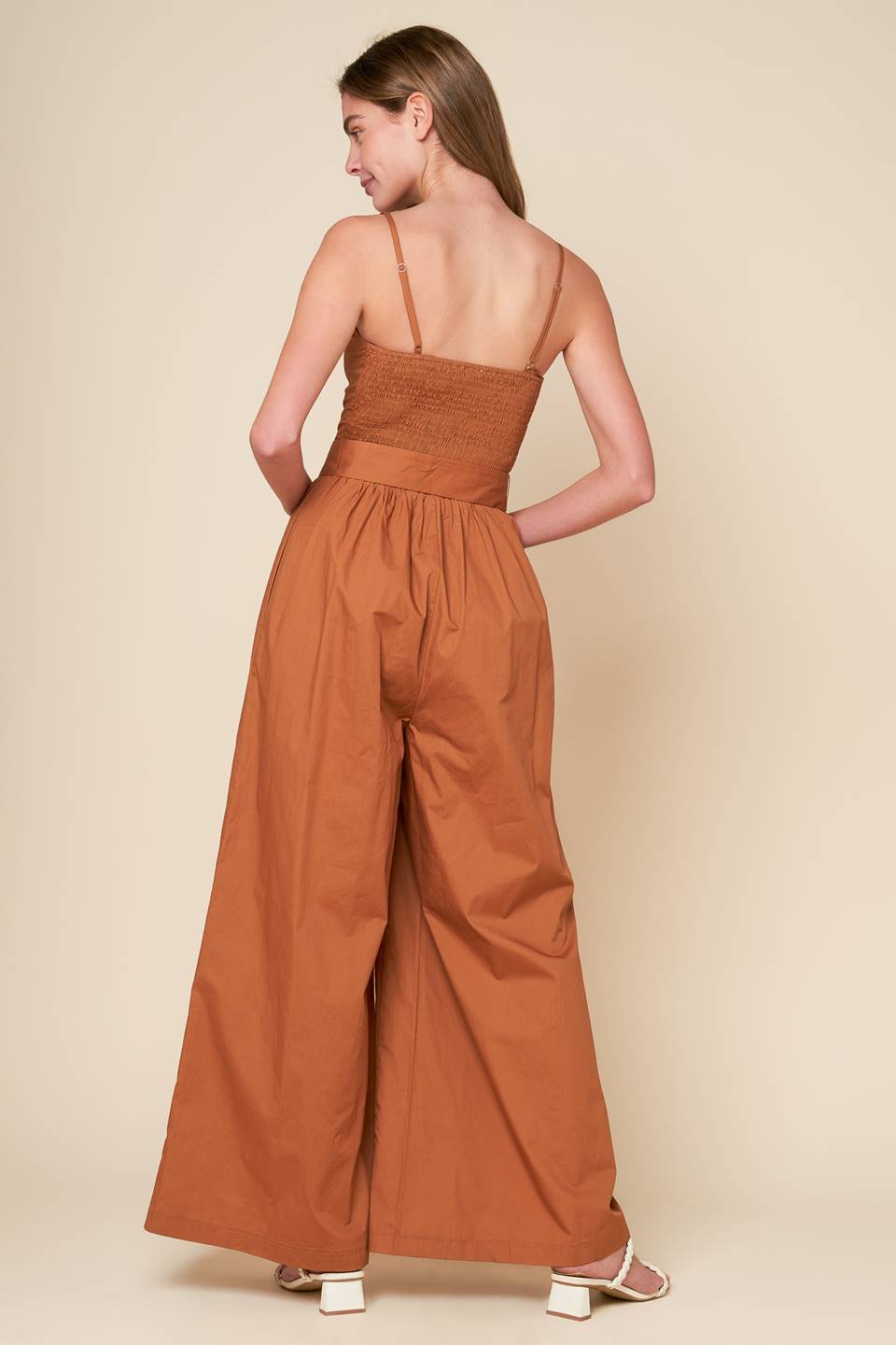 A stylish jumpsuit with a woven design and a cami top, complete with straps and a self belt. Also includes a smocked back bodice and wide leg for added comfort.