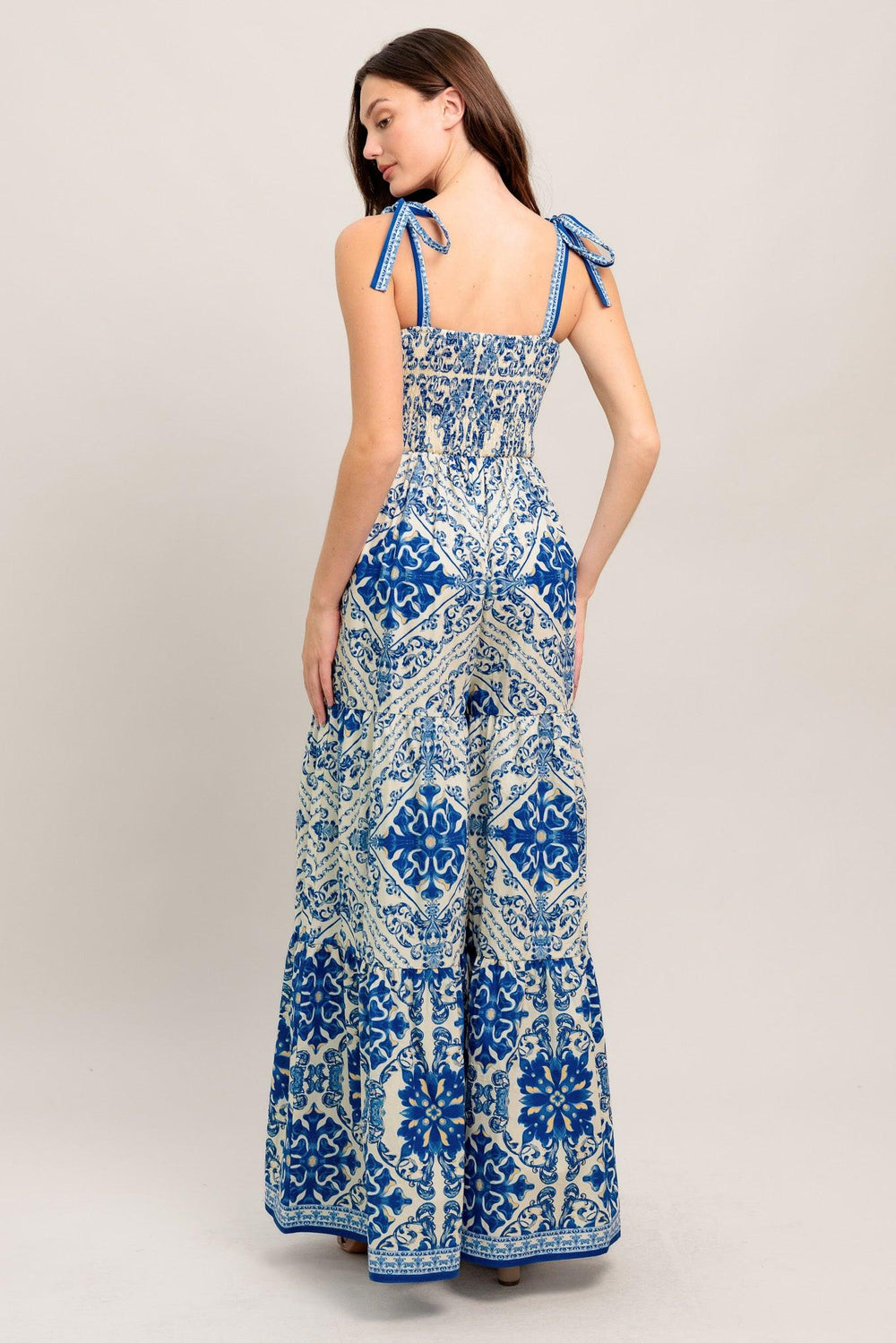 
A printed woven jumpsuit featuring sweetheart neckline, shoulder tie, tiered pant and smocked back bodice

Details:

Self : 100% Cotton

Size &amp; Fit

- Model is 5`8" And Wearing Size Small
- Measurements Taken From Size Small
- Approx. Length: 58"