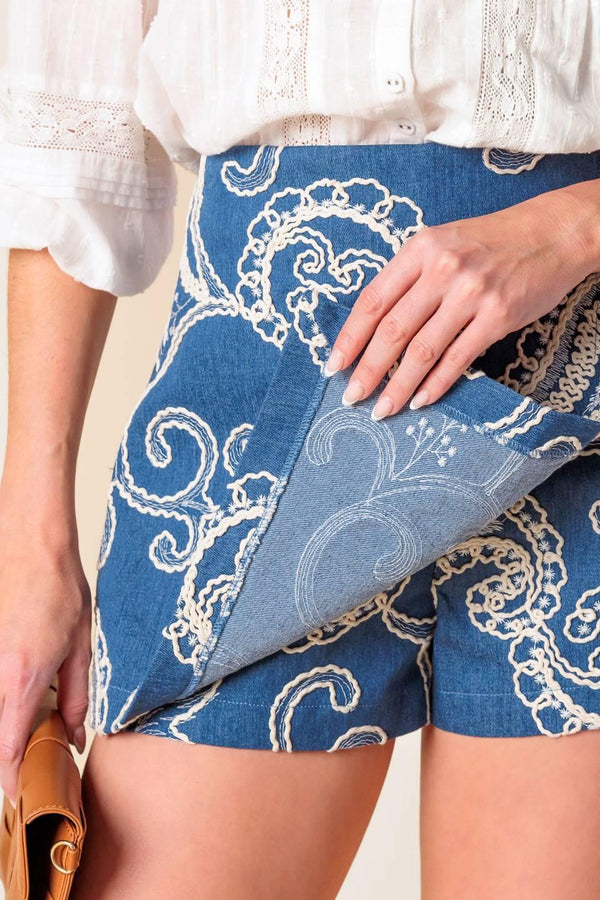 A textured denim woven mini skort with side zipper closure.