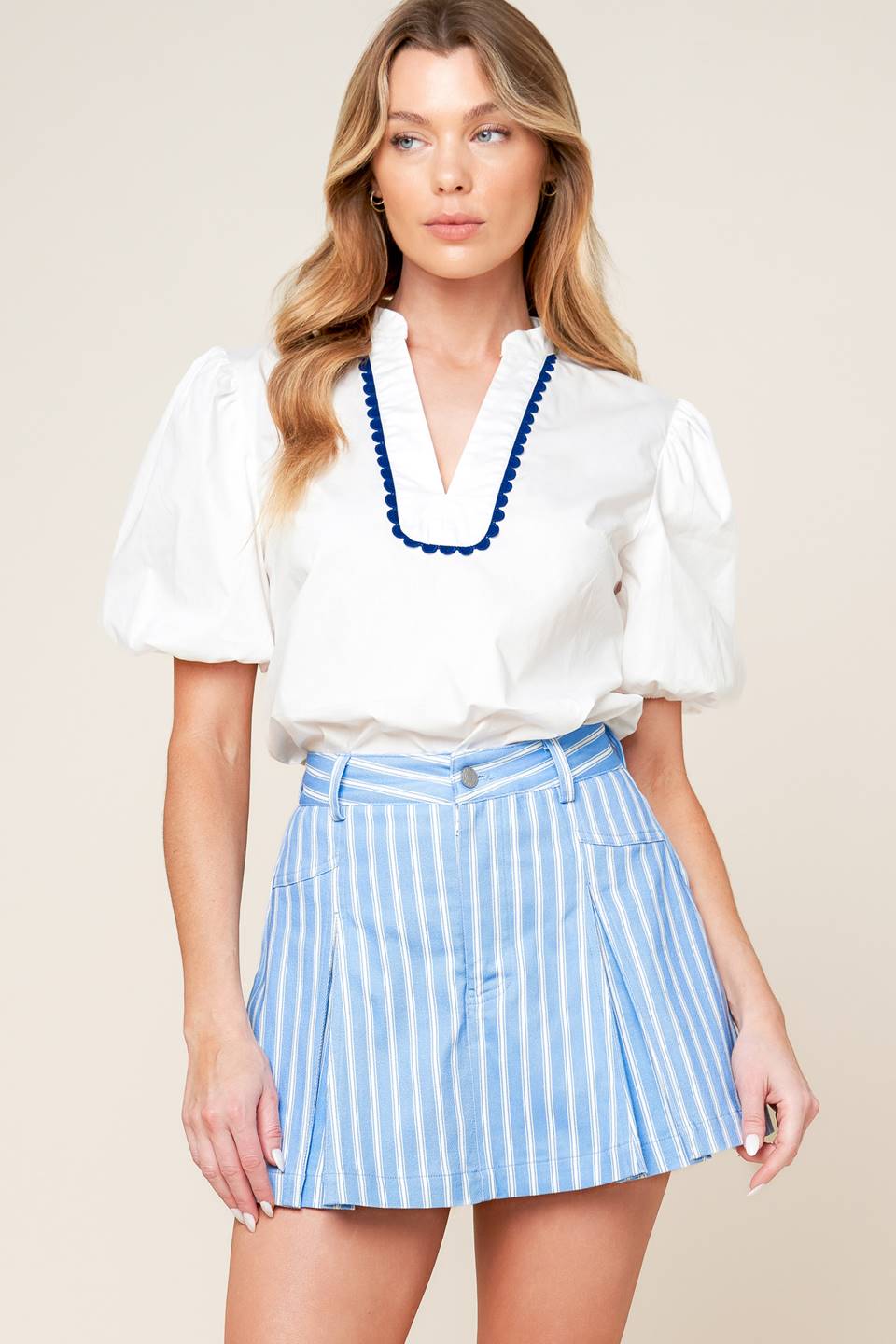 A blue & white striped woven skort featuring front closure and inverted pleats