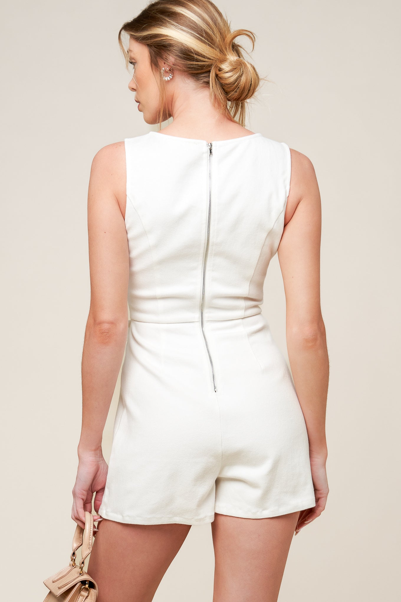 A solid white woven skort romper featuring round neckline, sleeveless, side bow detail and back zipper closure.

Details:

Self : 97% Cotton 3% Spandex

Size &amp; Fit

- Model is 5`8" And Wearing Size Small
- Measurements Taken From Size Small
- Approx. Length: 32" FLYING TOMATO