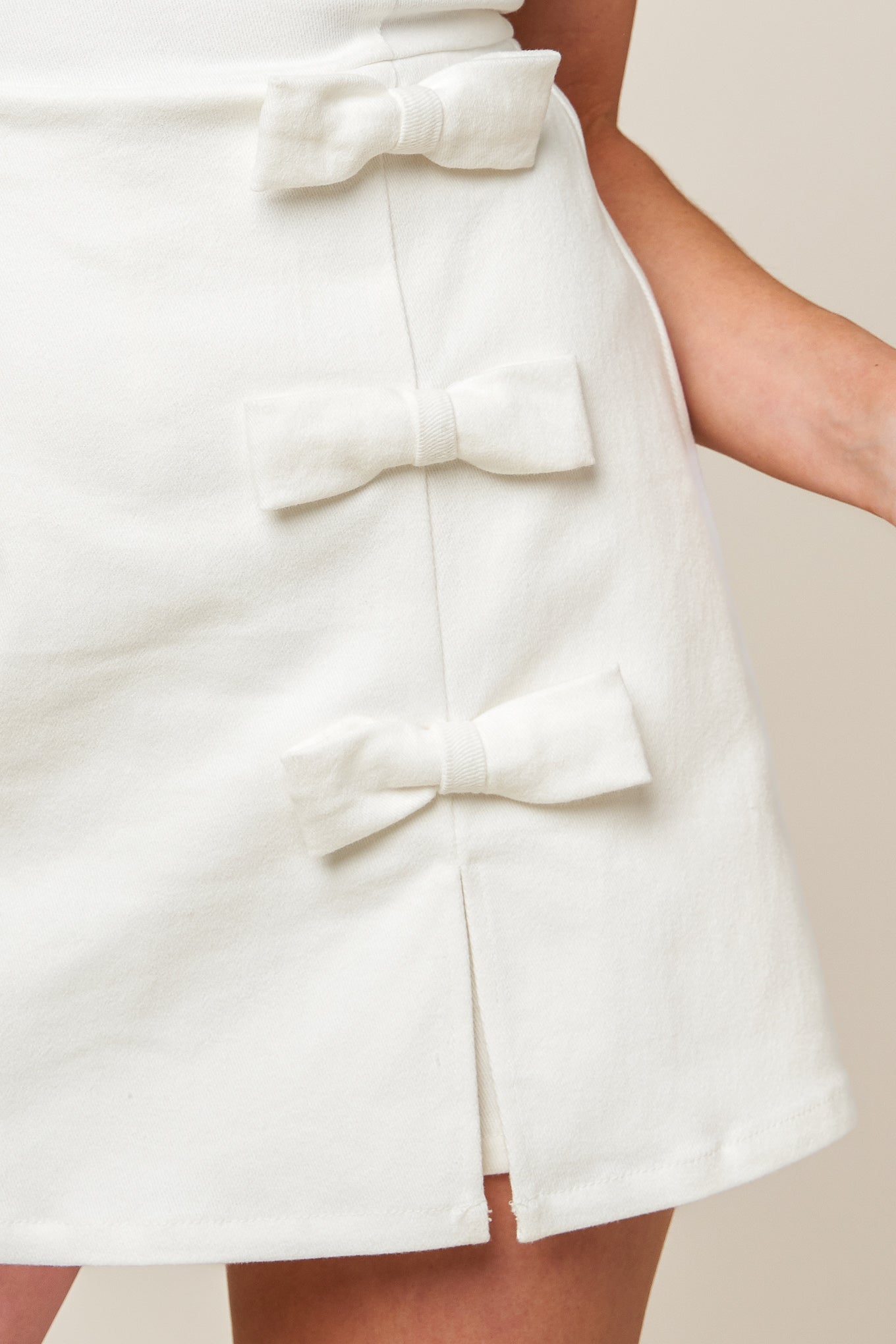 A solid white woven skort romper featuring round neckline, sleeveless, side bow detail and back zipper closure.

Details:

Self : 97% Cotton 3% Spandex

Size &amp; Fit

- Model is 5`8" And Wearing Size Small
- Measurements Taken From Size Small
- Approx. Length: 32" FLYING TOMATO